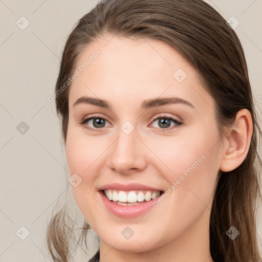 Joyful white young-adult female with long  brown hair and grey eyes