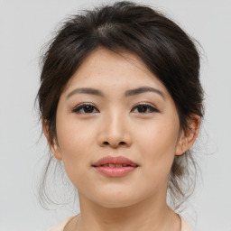 Joyful asian young-adult female with medium  brown hair and brown eyes