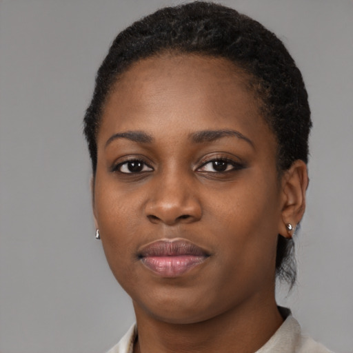 Joyful black young-adult female with short  black hair and brown eyes