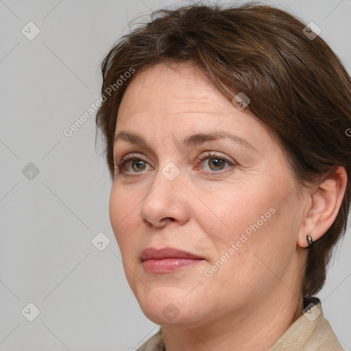 Joyful white adult female with medium  brown hair and grey eyes