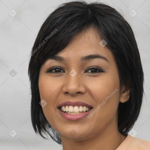 Joyful asian young-adult female with medium  black hair and brown eyes