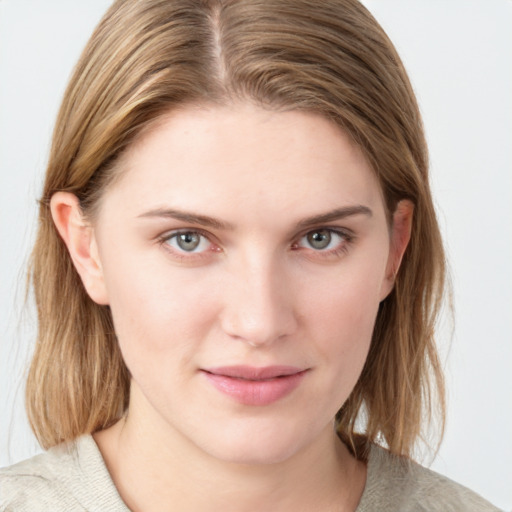 Joyful white young-adult female with medium  brown hair and blue eyes