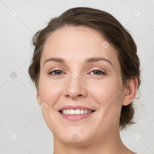 Joyful white young-adult female with medium  brown hair and grey eyes