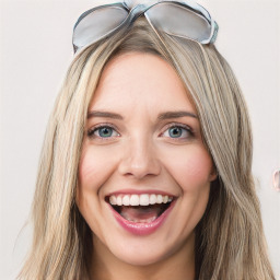 Joyful white young-adult female with long  brown hair and blue eyes