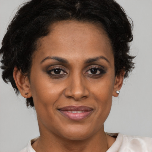 Joyful latino adult female with short  brown hair and brown eyes