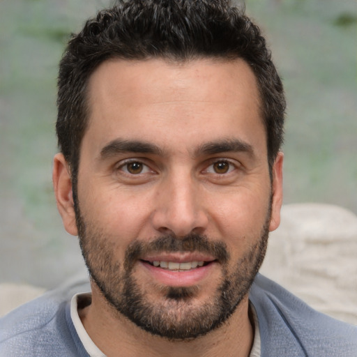 Joyful white adult male with short  brown hair and brown eyes