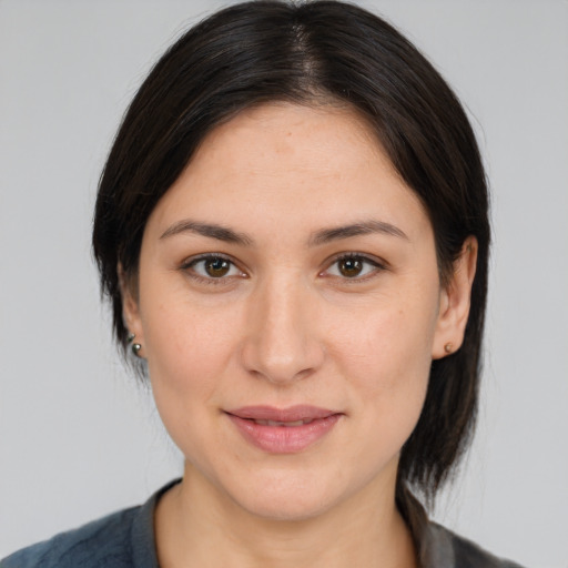 Joyful white young-adult female with medium  brown hair and brown eyes