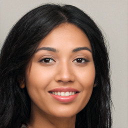 Joyful latino young-adult female with long  brown hair and brown eyes