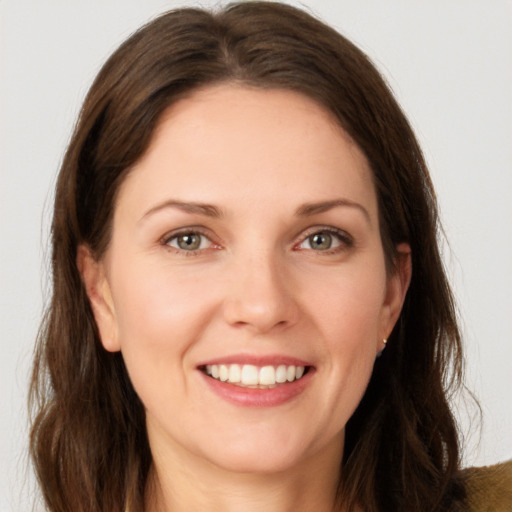 Joyful white young-adult female with long  brown hair and brown eyes