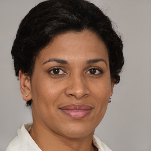 Joyful latino adult female with short  brown hair and brown eyes