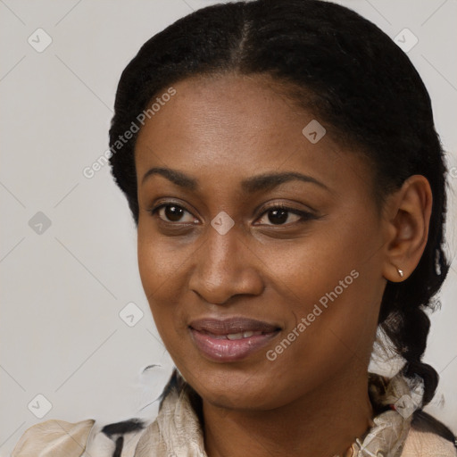 Joyful black young-adult female with long  black hair and brown eyes