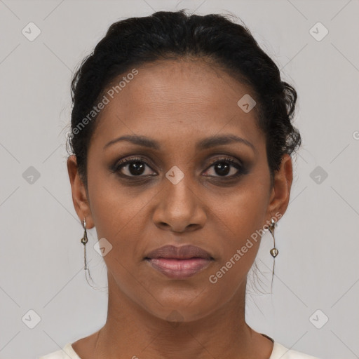 Joyful black young-adult female with short  brown hair and brown eyes
