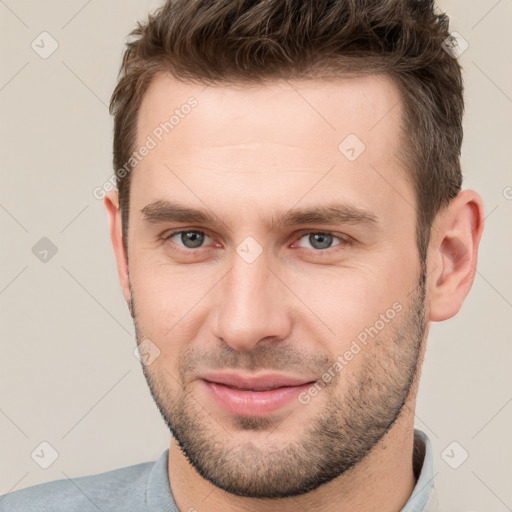 Joyful white young-adult male with short  brown hair and brown eyes