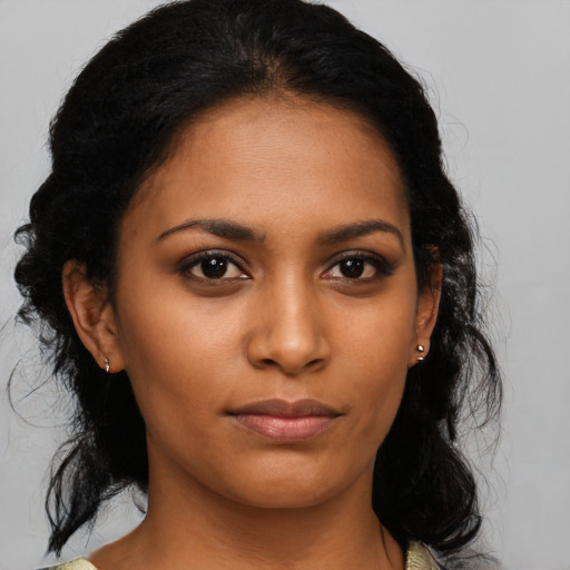 Joyful black young-adult female with medium  black hair and brown eyes