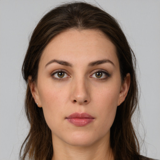 Neutral white young-adult female with long  brown hair and brown eyes