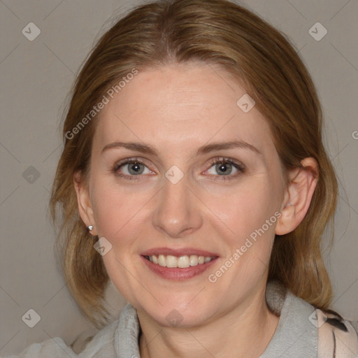 Joyful white adult female with medium  brown hair and blue eyes