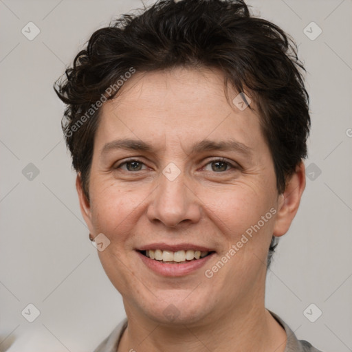 Joyful white adult female with short  brown hair and brown eyes