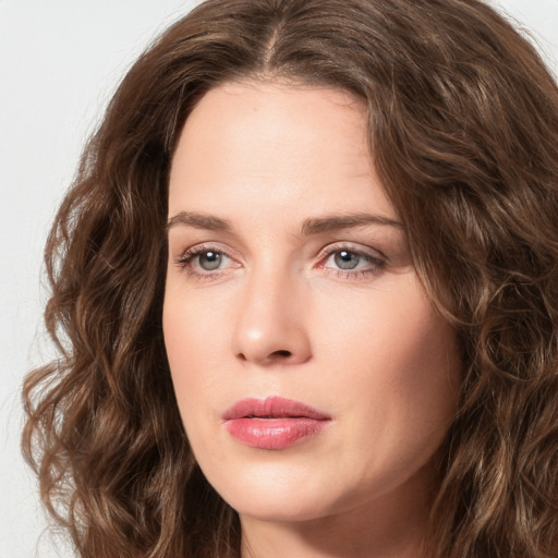 Joyful white young-adult female with long  brown hair and green eyes