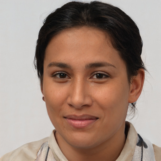 Joyful latino young-adult female with short  brown hair and brown eyes