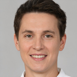 Joyful white adult male with short  brown hair and brown eyes