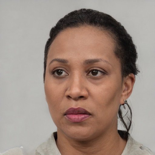 Joyful latino adult female with short  black hair and brown eyes