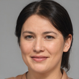 Joyful white adult female with medium  brown hair and brown eyes