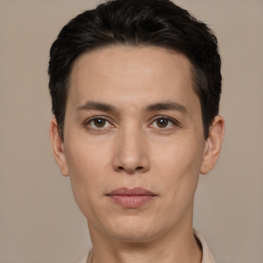 Joyful white adult male with short  black hair and brown eyes