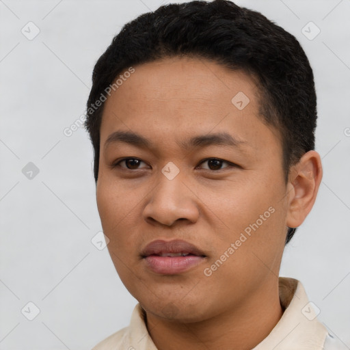 Joyful latino young-adult male with short  black hair and brown eyes