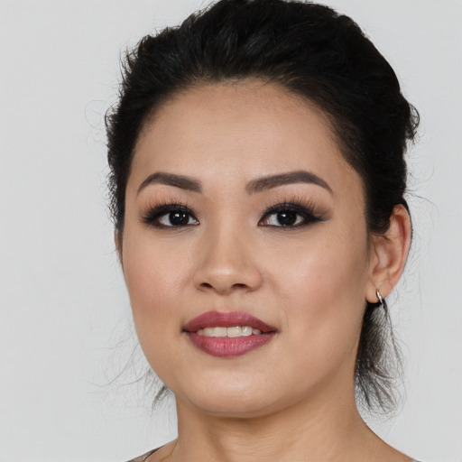 Joyful asian young-adult female with long  black hair and brown eyes