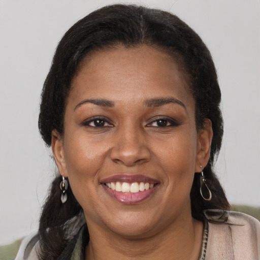 Joyful black adult female with short  brown hair and brown eyes