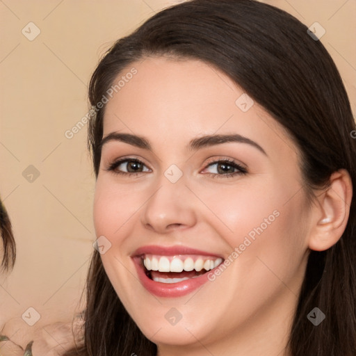 Joyful white young-adult female with long  brown hair and brown eyes