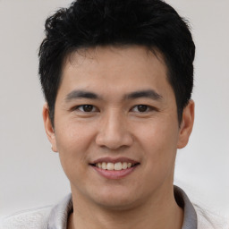 Joyful asian young-adult male with short  black hair and brown eyes