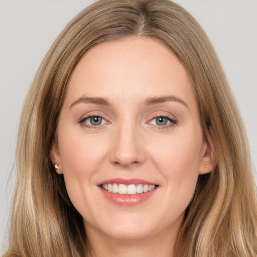 Joyful white young-adult female with long  brown hair and brown eyes