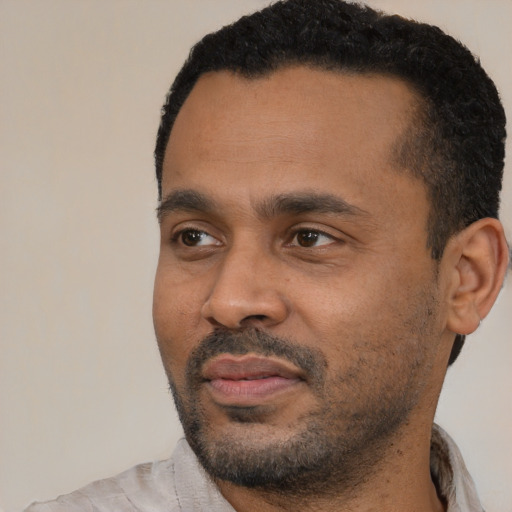 Neutral latino adult male with short  black hair and brown eyes
