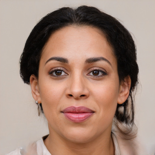 Joyful latino adult female with medium  brown hair and brown eyes
