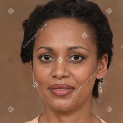 Joyful black adult female with medium  brown hair and brown eyes