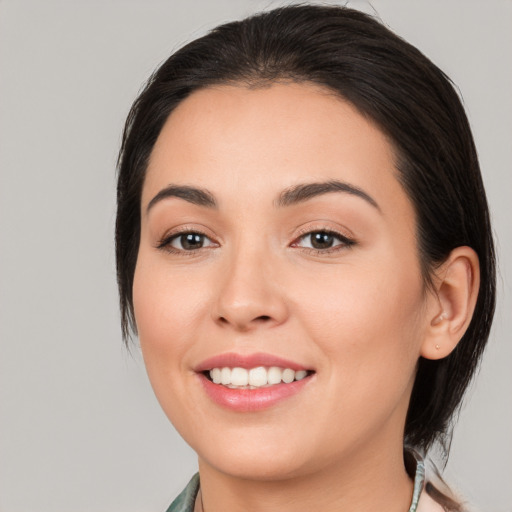 Joyful white young-adult female with medium  black hair and brown eyes