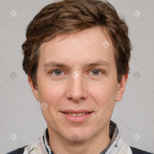 Joyful white adult male with short  brown hair and grey eyes