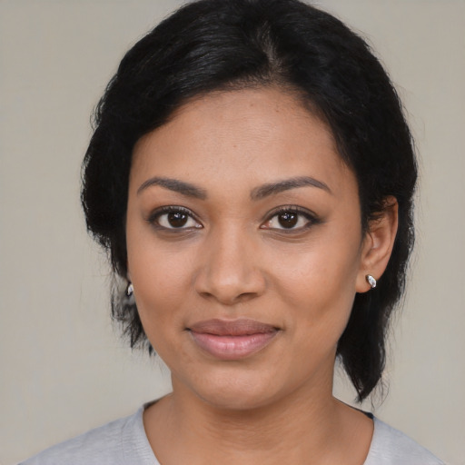 Joyful latino young-adult female with medium  black hair and brown eyes
