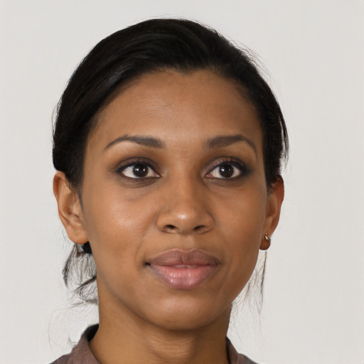 Joyful black young-adult female with medium  brown hair and brown eyes