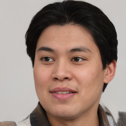 Joyful asian young-adult male with short  brown hair and brown eyes