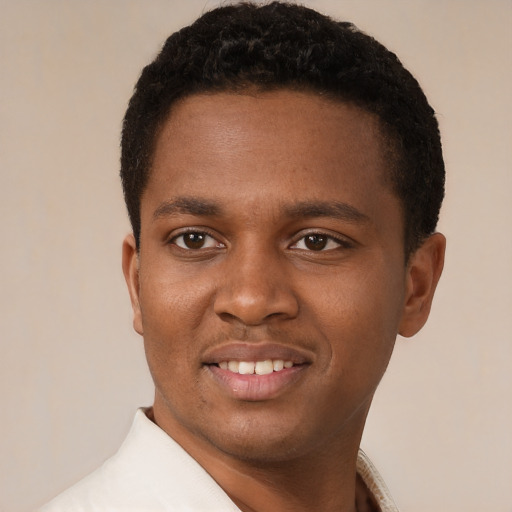 Joyful latino young-adult male with short  brown hair and brown eyes