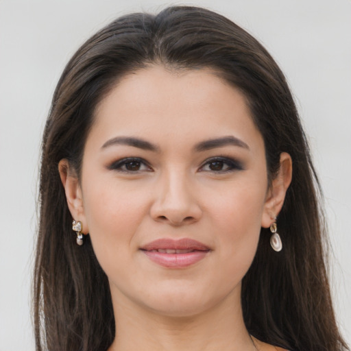 Joyful latino young-adult female with long  brown hair and brown eyes