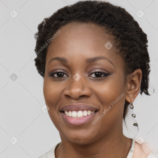 Joyful black young-adult female with short  brown hair and brown eyes