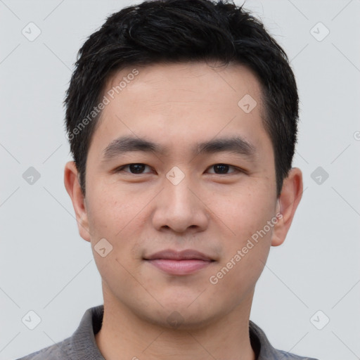 Joyful asian young-adult male with short  black hair and brown eyes