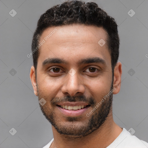 Joyful white young-adult male with short  black hair and brown eyes