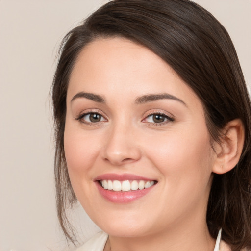 Joyful white young-adult female with medium  brown hair and brown eyes