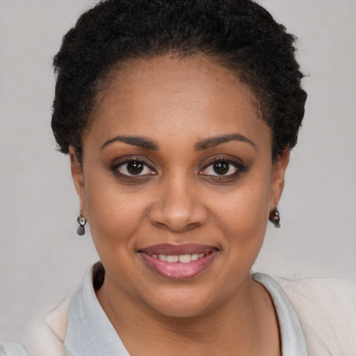 Joyful black young-adult female with short  brown hair and brown eyes