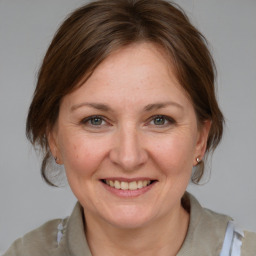 Joyful white adult female with medium  brown hair and brown eyes