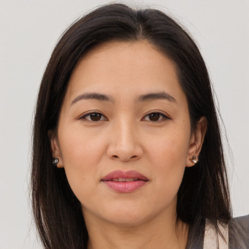 Joyful asian young-adult female with long  brown hair and brown eyes